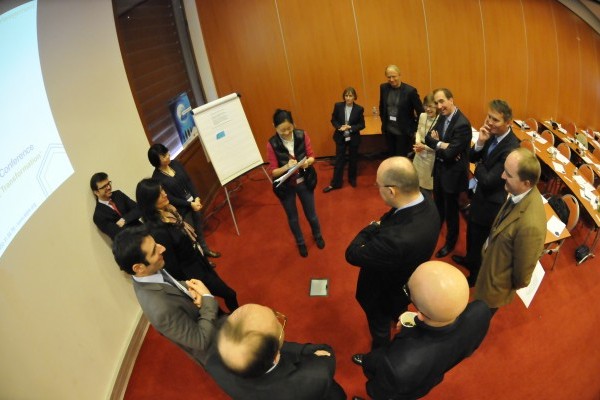 Workshop: a fish-eye shot of a group of people discussing during a workshop session