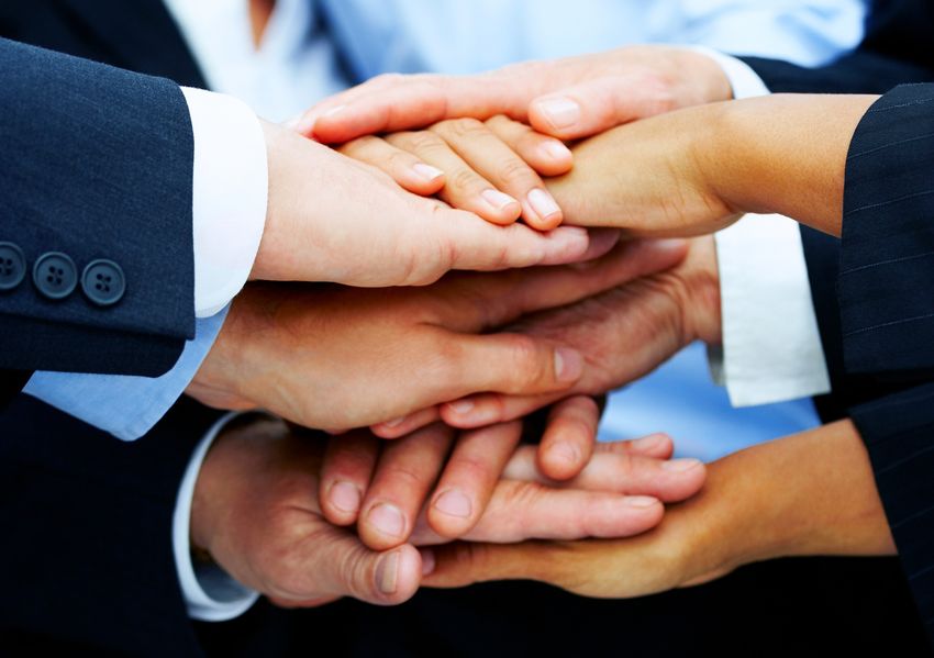 Teamwork and team spirit - Hands piled on top of one another.